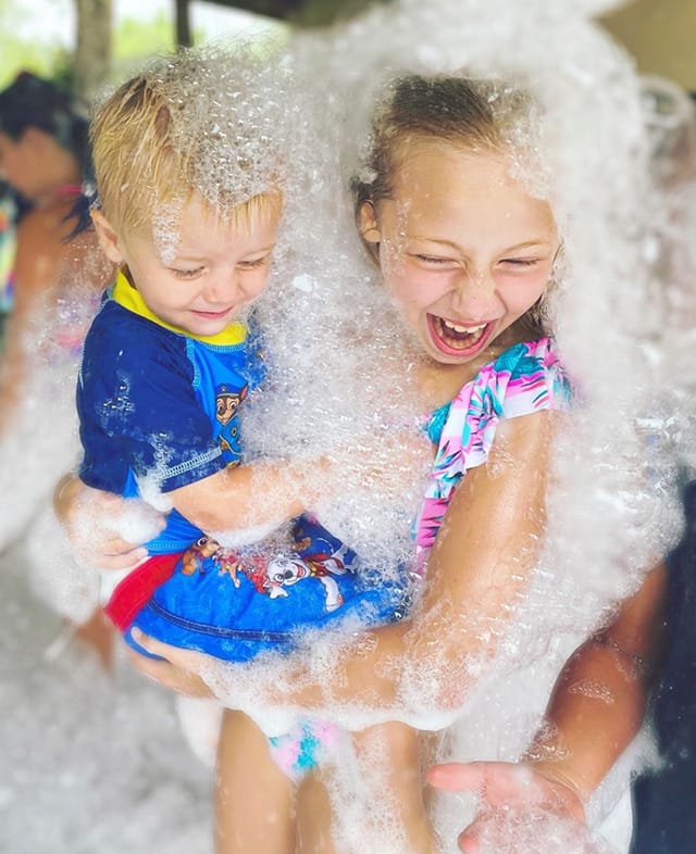 Two kids playing in foam